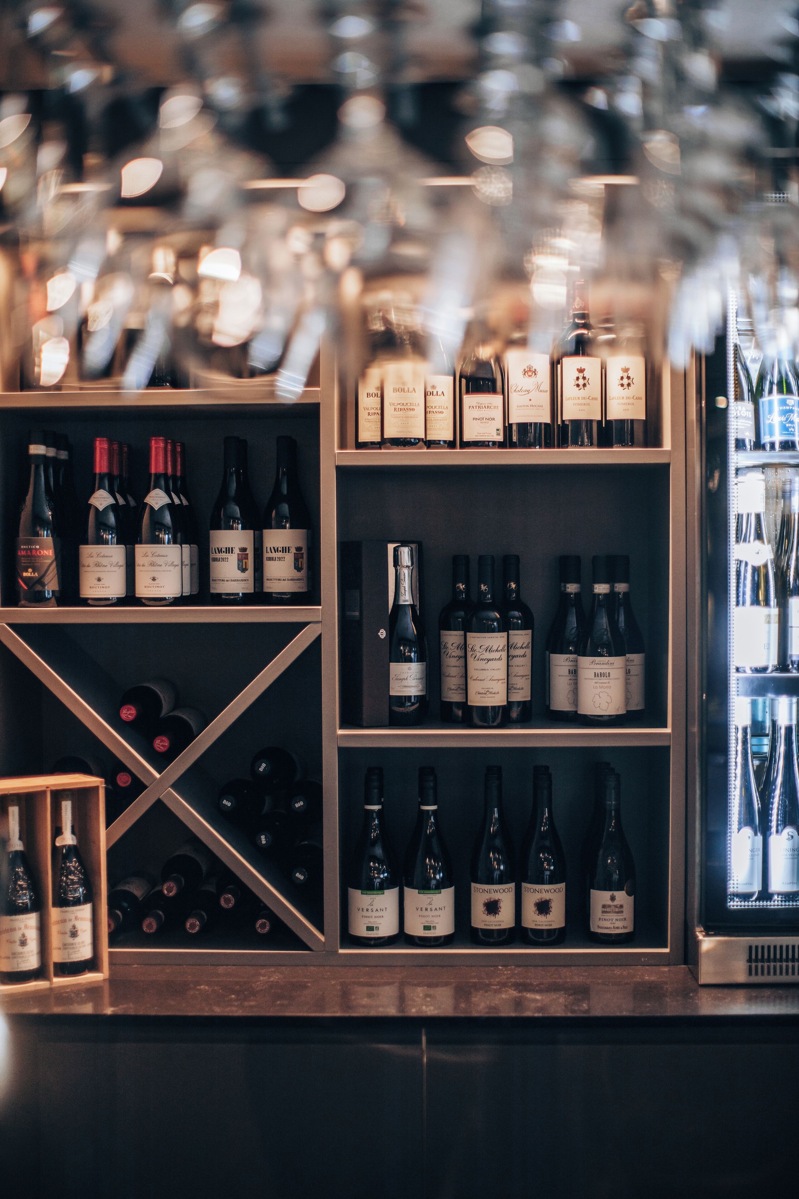 A wine rack with various bottles of wine.