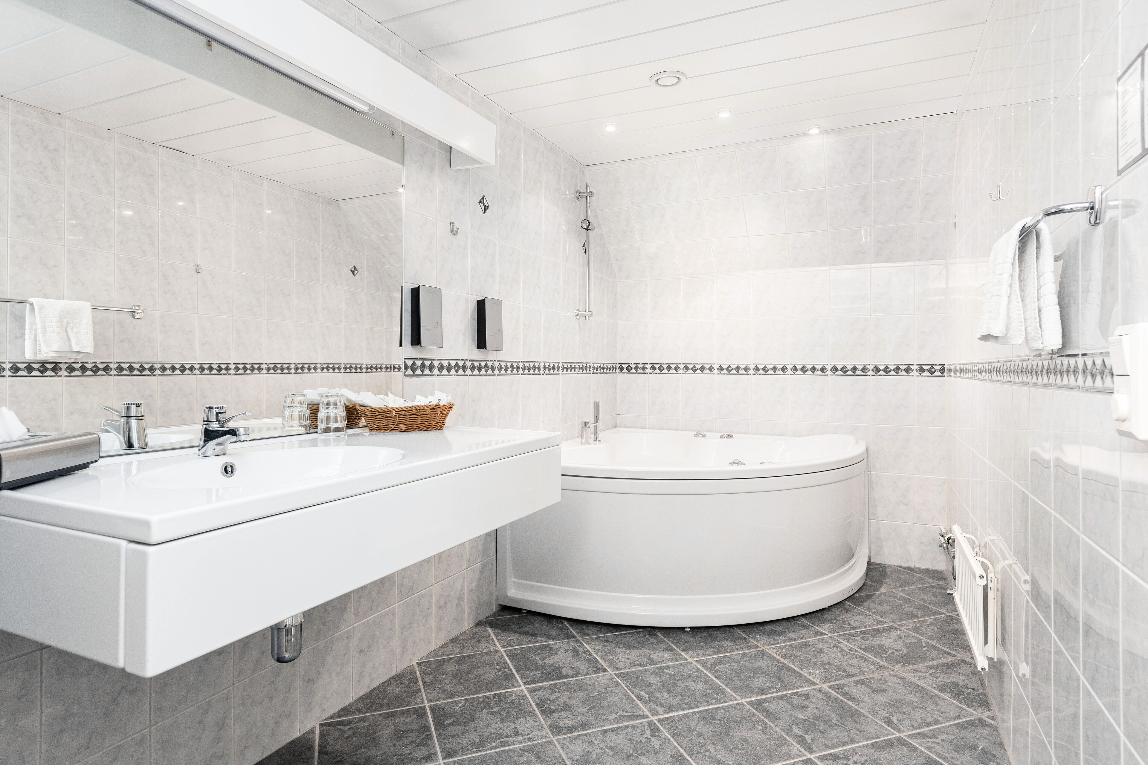 Un baño moderno con un lavabo grande, una bañera y una ducha.