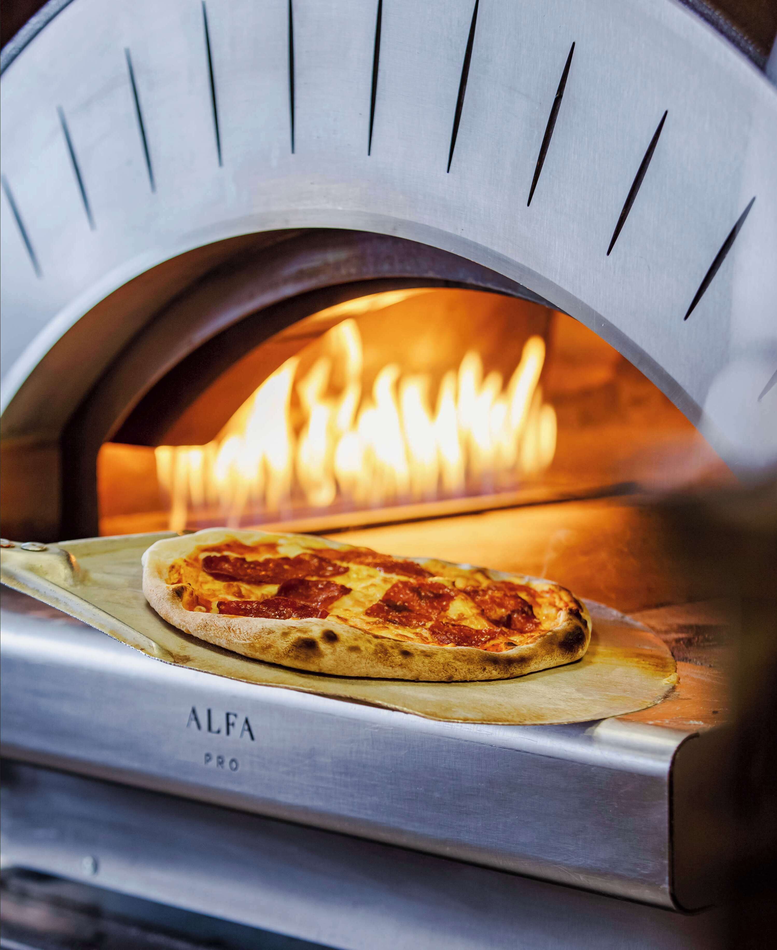 A pizza oven with a pizza inside.