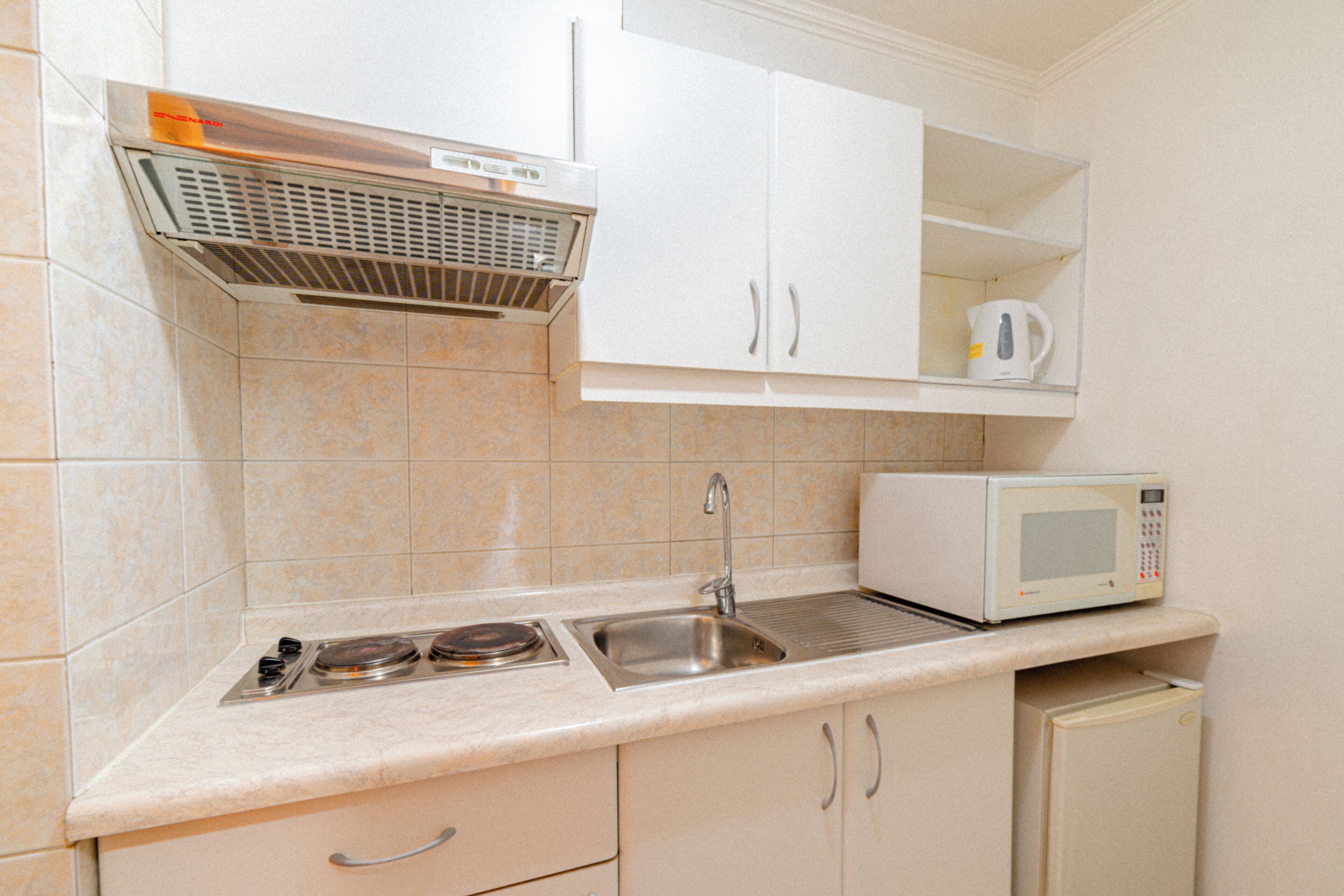 Full-size fridge, microwave, cookware/dishes/utensils