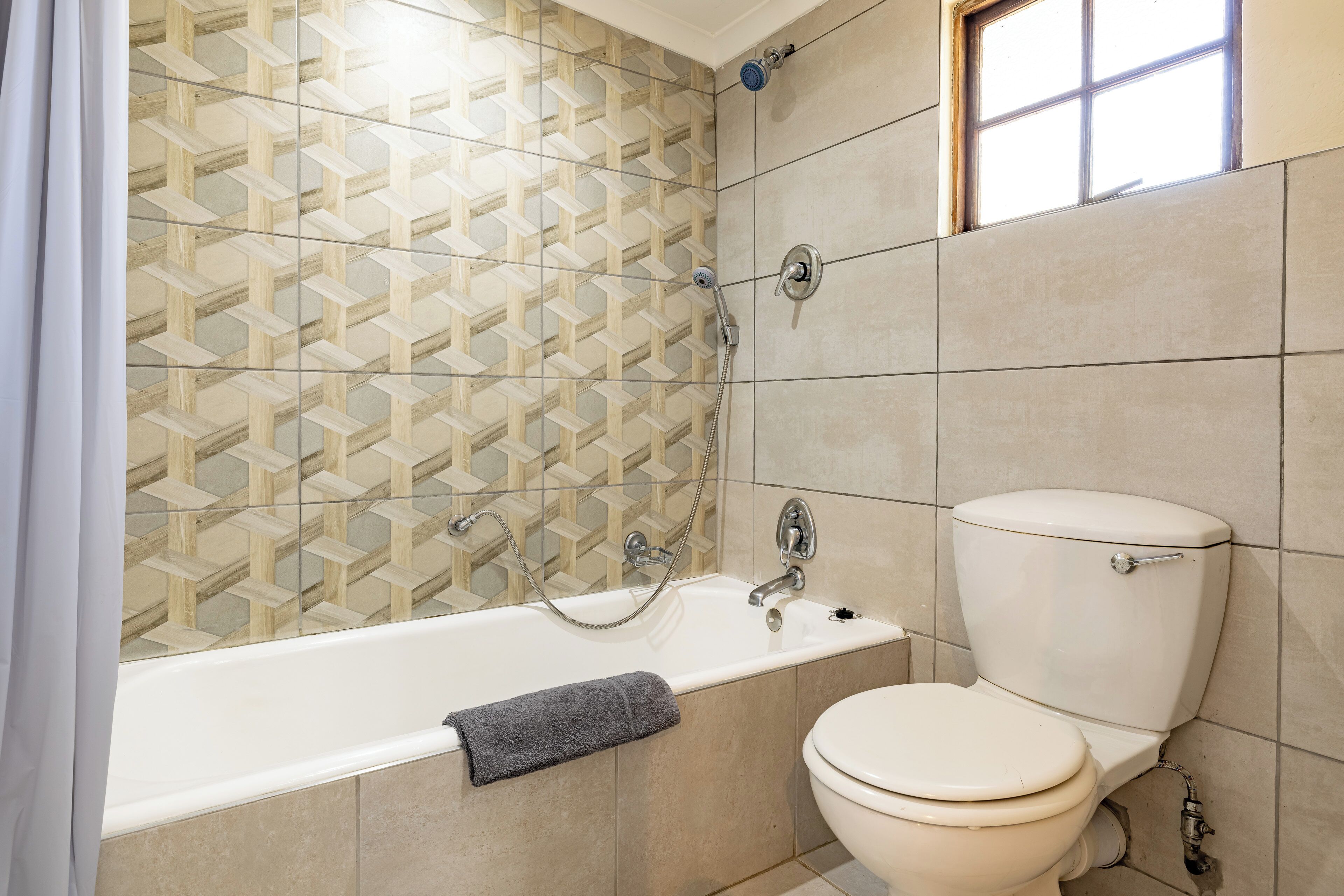 A bathroom with a bathtub, toilet, and a shower.