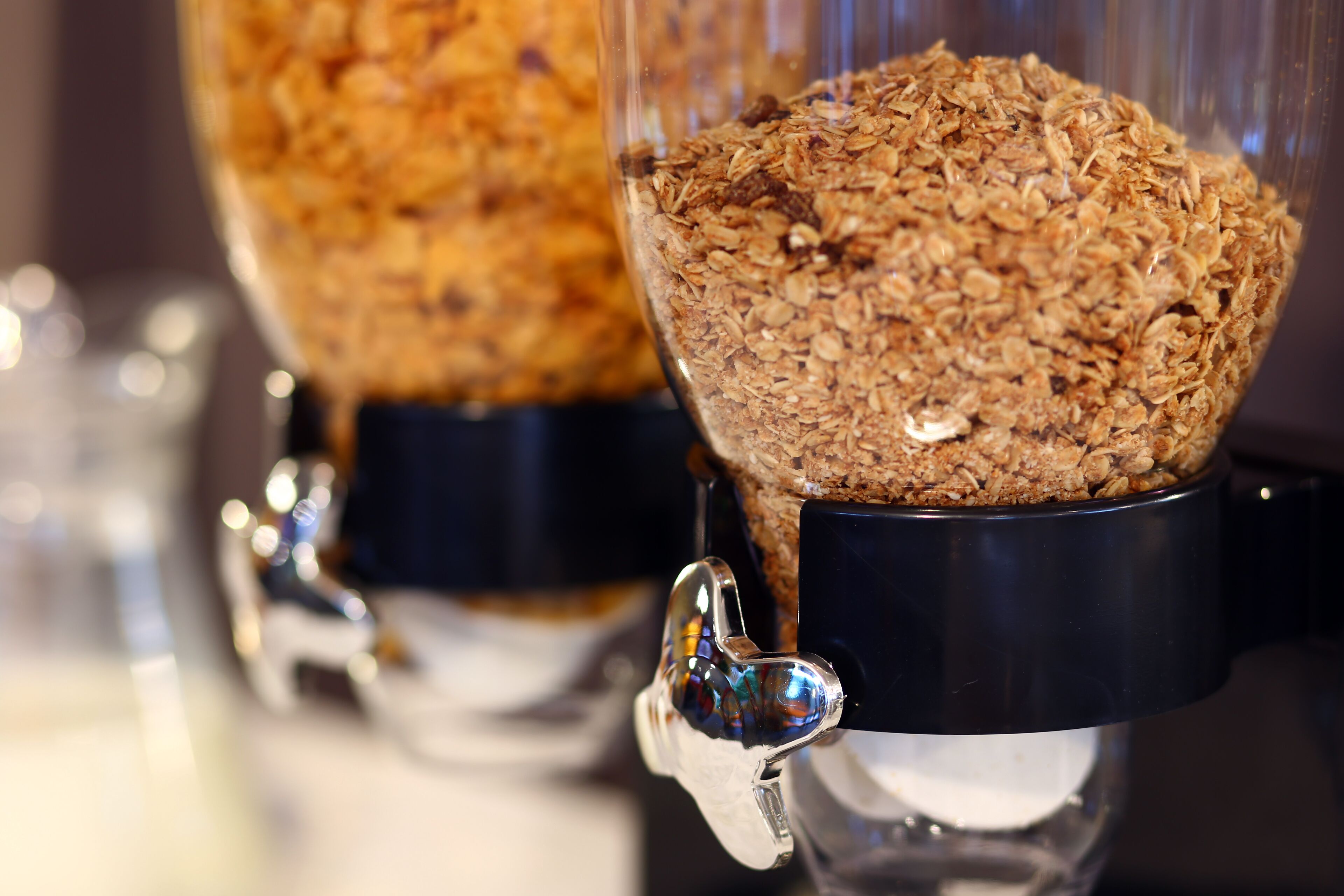 A close-up of a blender with a transparent container filled with granola.