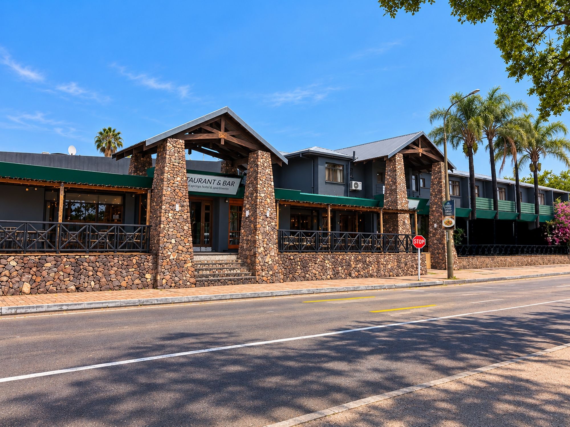 A restaurant with a stone facade and a sign indicating it is a restaurant and bar.
