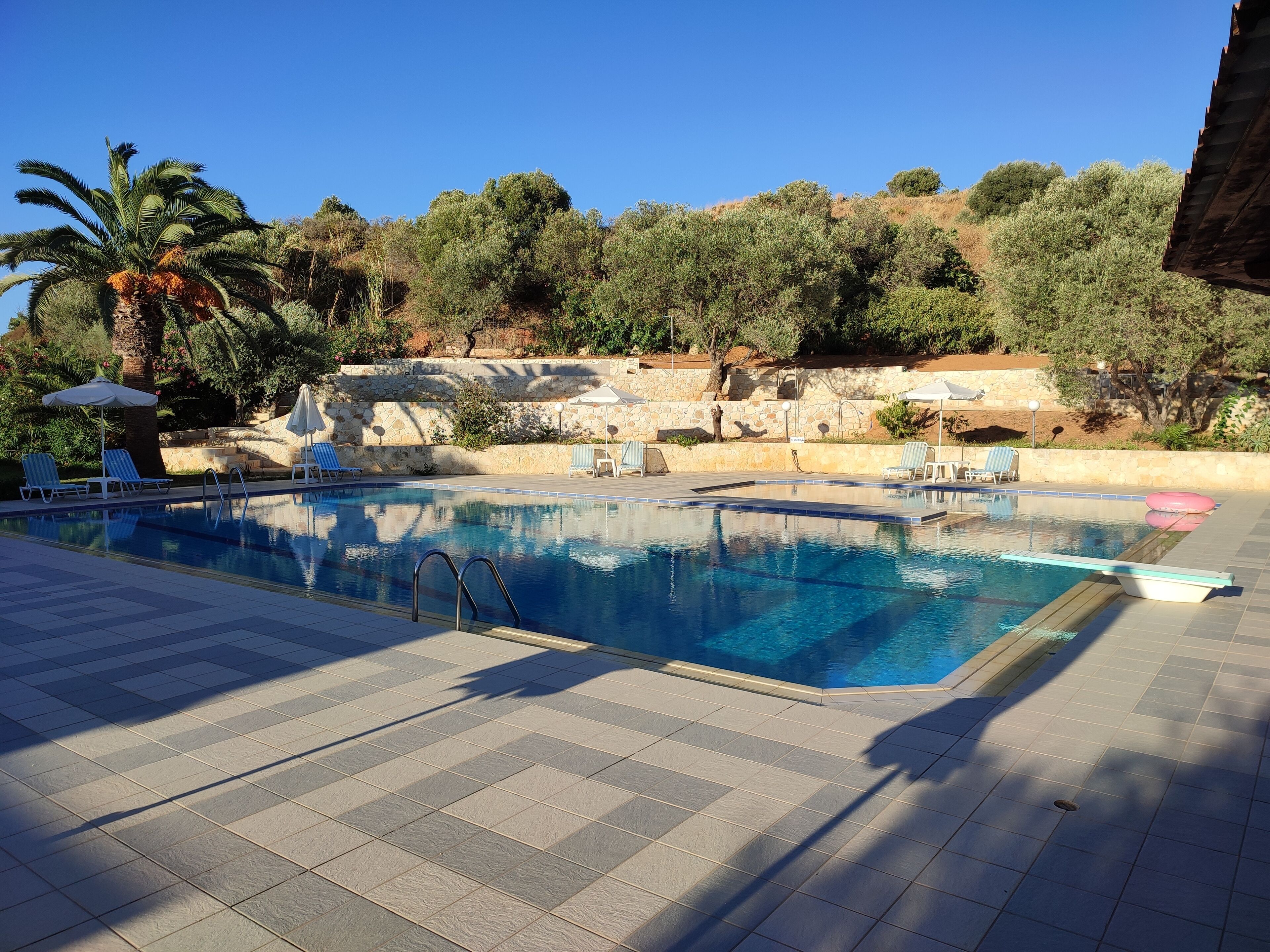 seasonal outdoor pool, open 9:00 am to 7:00 pm, pool umbrellas