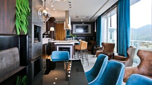 A modern interior with a kitchen, dining area, and seating. - Sandri Palace Hotel (Itajai)