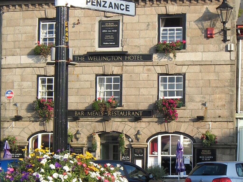 The Wellington Hotel with a sign for a bar and restaurant.