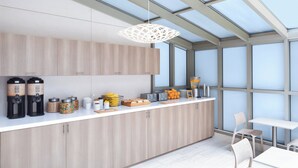 A modern kitchen with a skylight, built-in appliances, and a breakfast bar.
