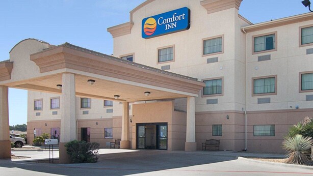 A Comfort Inn hotel with a covered entrance and multiple windows. - Comfort Inn I-20 Midland Stanton (Stanton)