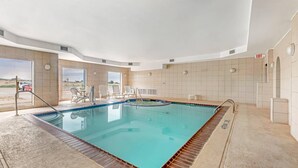 A swimming pool with a tiled deck, a sunroof, and a view of the outdoors. - Comfort Inn I-20 Midland Stanton (Stanton)