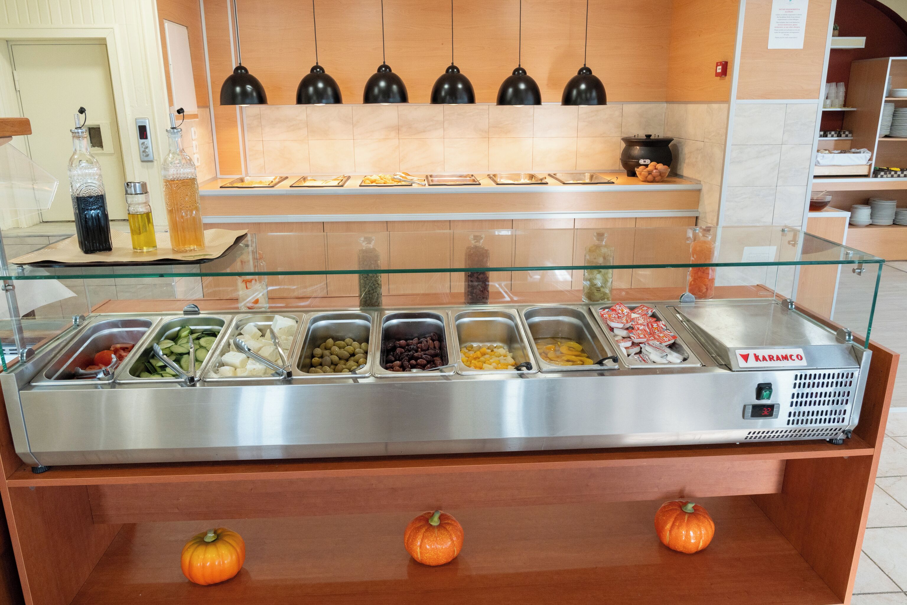 A buffet with various food options and a Karamo branded coffee machine.