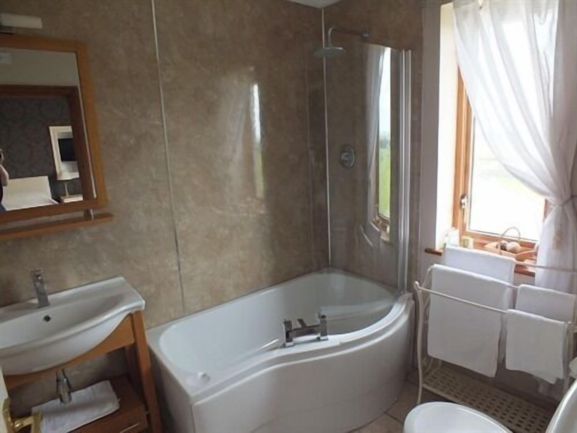 A bathroom with a bathtub, a sink, and a shower.