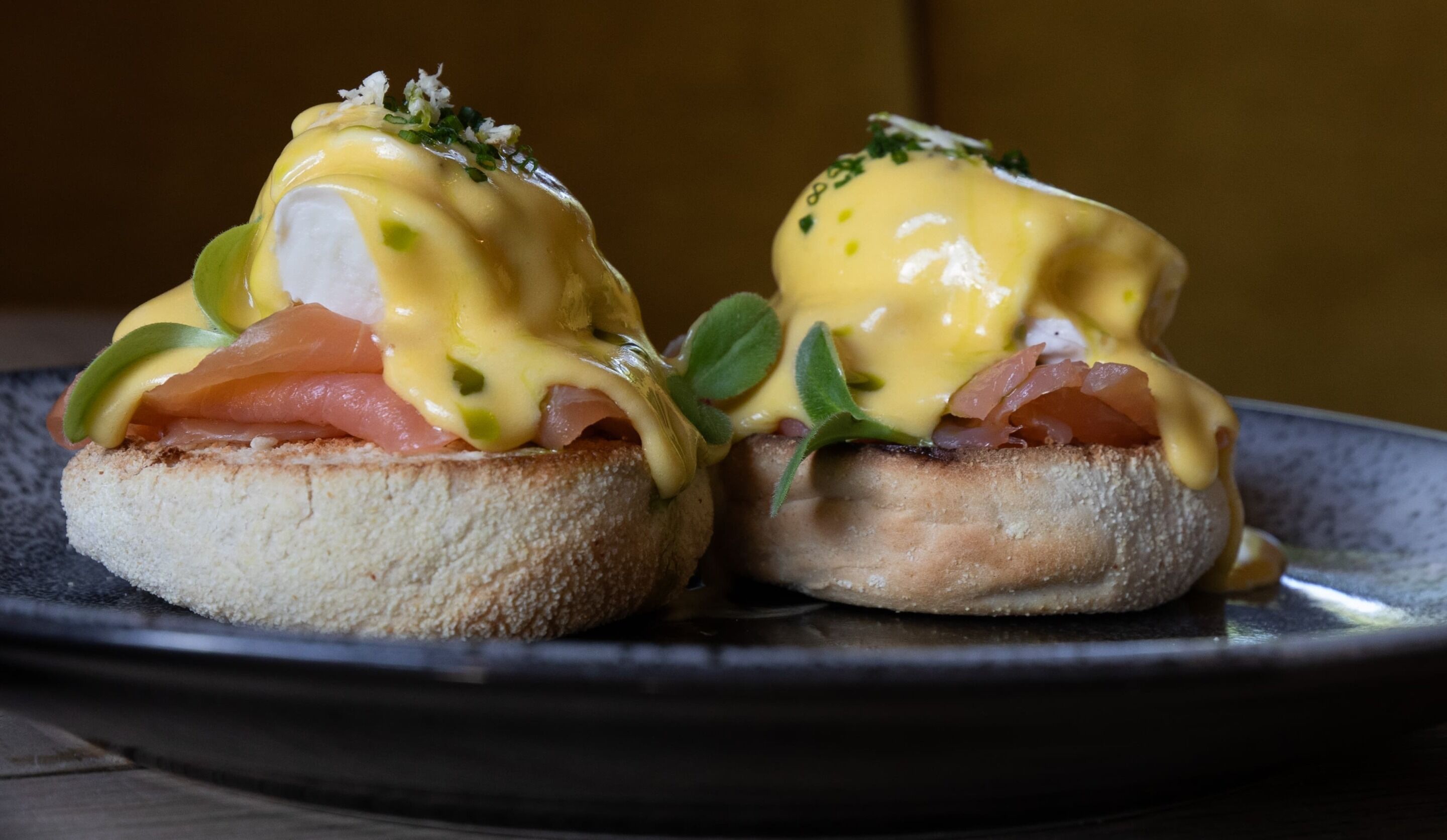 A plate with two eggs benedict sandwiches.