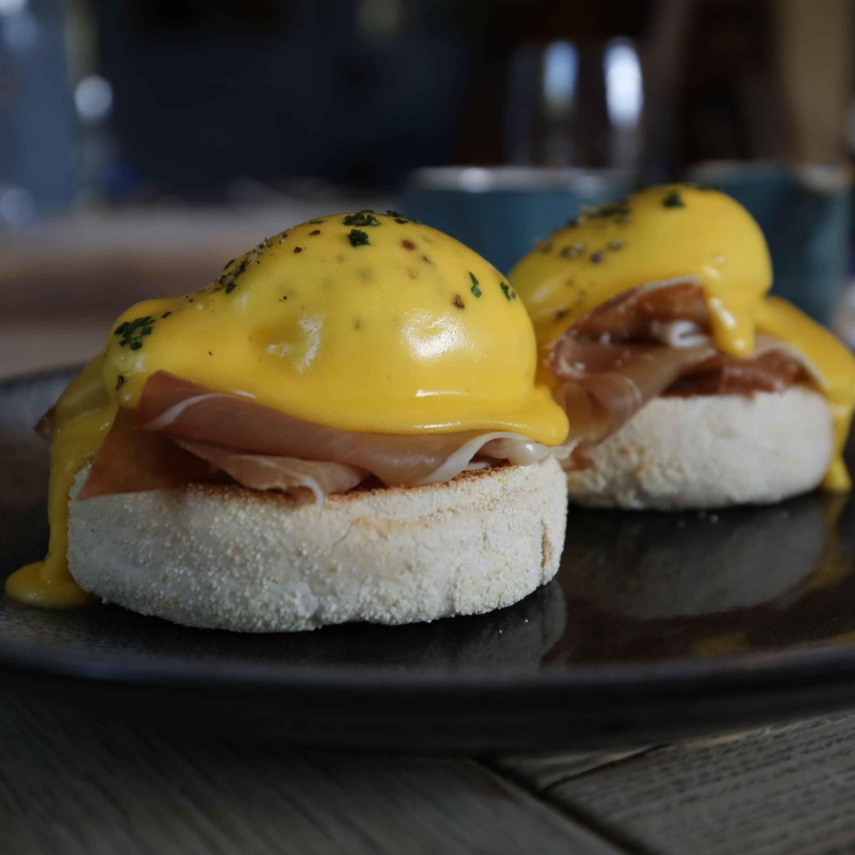 A breakfast dish with eggs benedict on a plate.