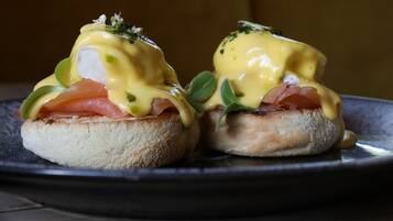 Two eggs benedict sandwiches on a plate.