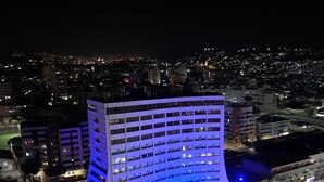A multi-story hotel with a prominent blue-lit facade and a sign reading "HOTEL CASINO INTERNACIONAL."