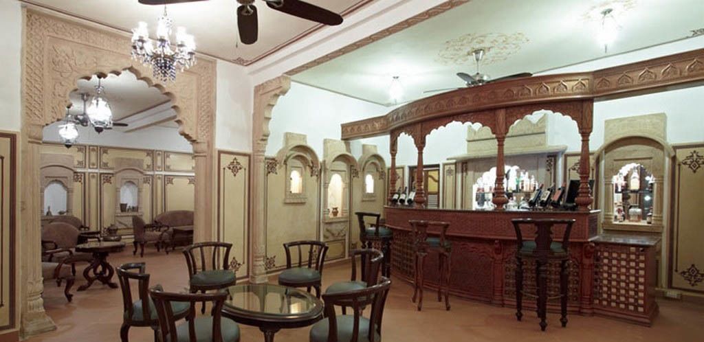A traditional interior with ornate arches, a bar area, and seating arrangements.
