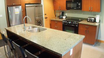 Suite, 2 Bedrooms | Private kitchen | Full-sized fridge, microwave, stovetop, dishwasher