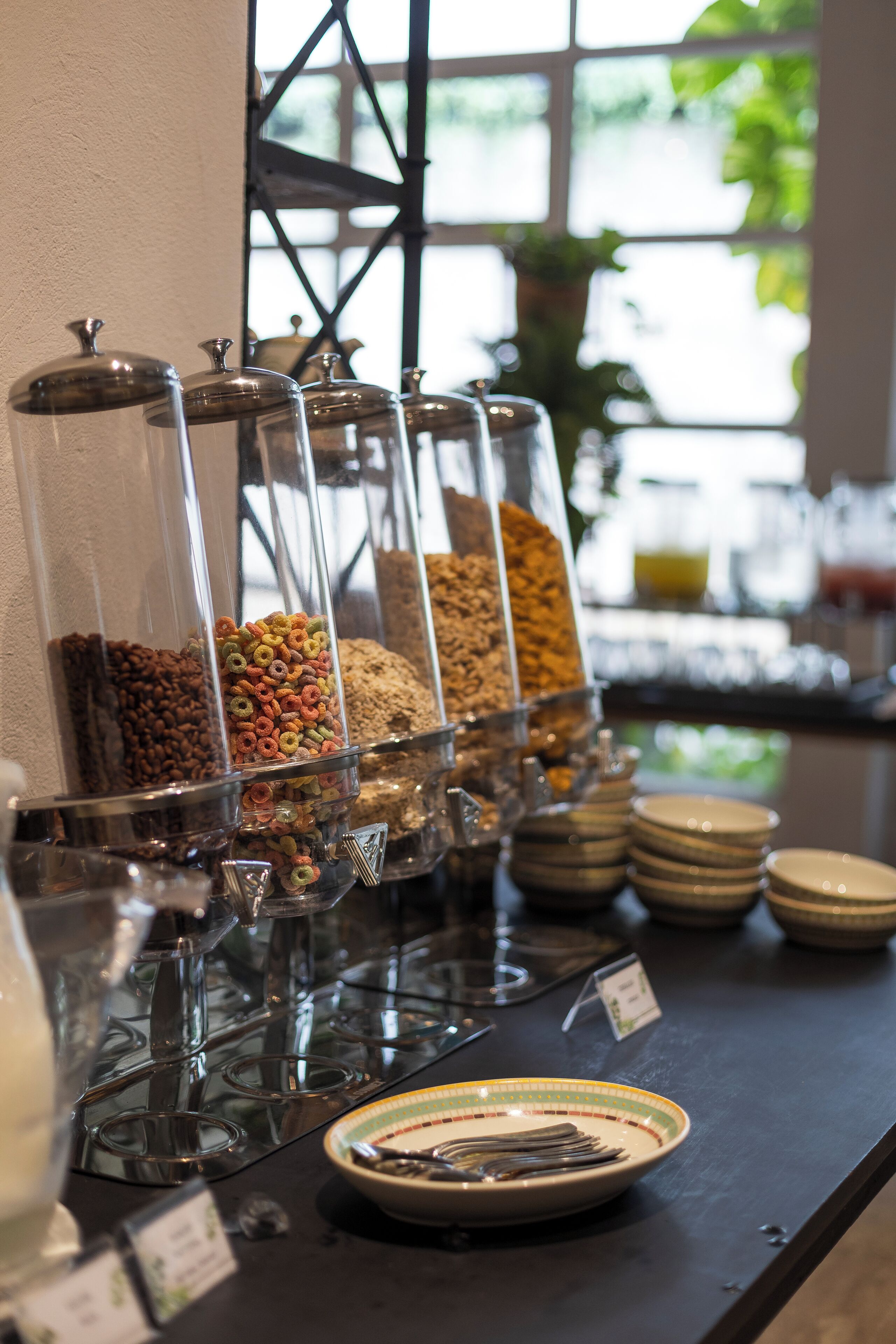 A buffet with various food containers and plates.