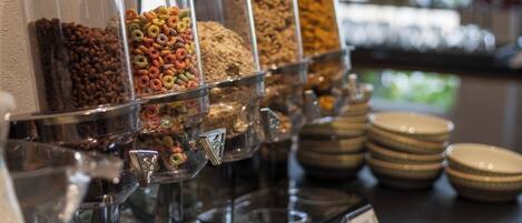 A buffet with various food containers and plates.