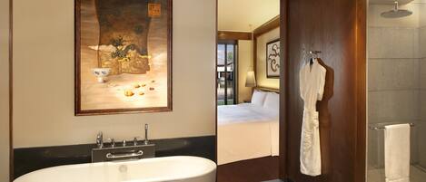 A modern bathroom with a freestanding bathtub, a wooden bath mat, and a towel rack.
