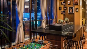 A modern room with a glass table, seating, and a city view. - Courtyard by Marriott Suzhou (Suzhou)