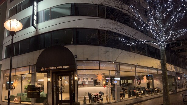 A hotel with a curved facade, large windows, and a sign reading "City Central Hotel Ørebro".