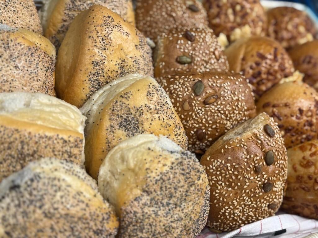 A variety of bread rolls with different toppings.