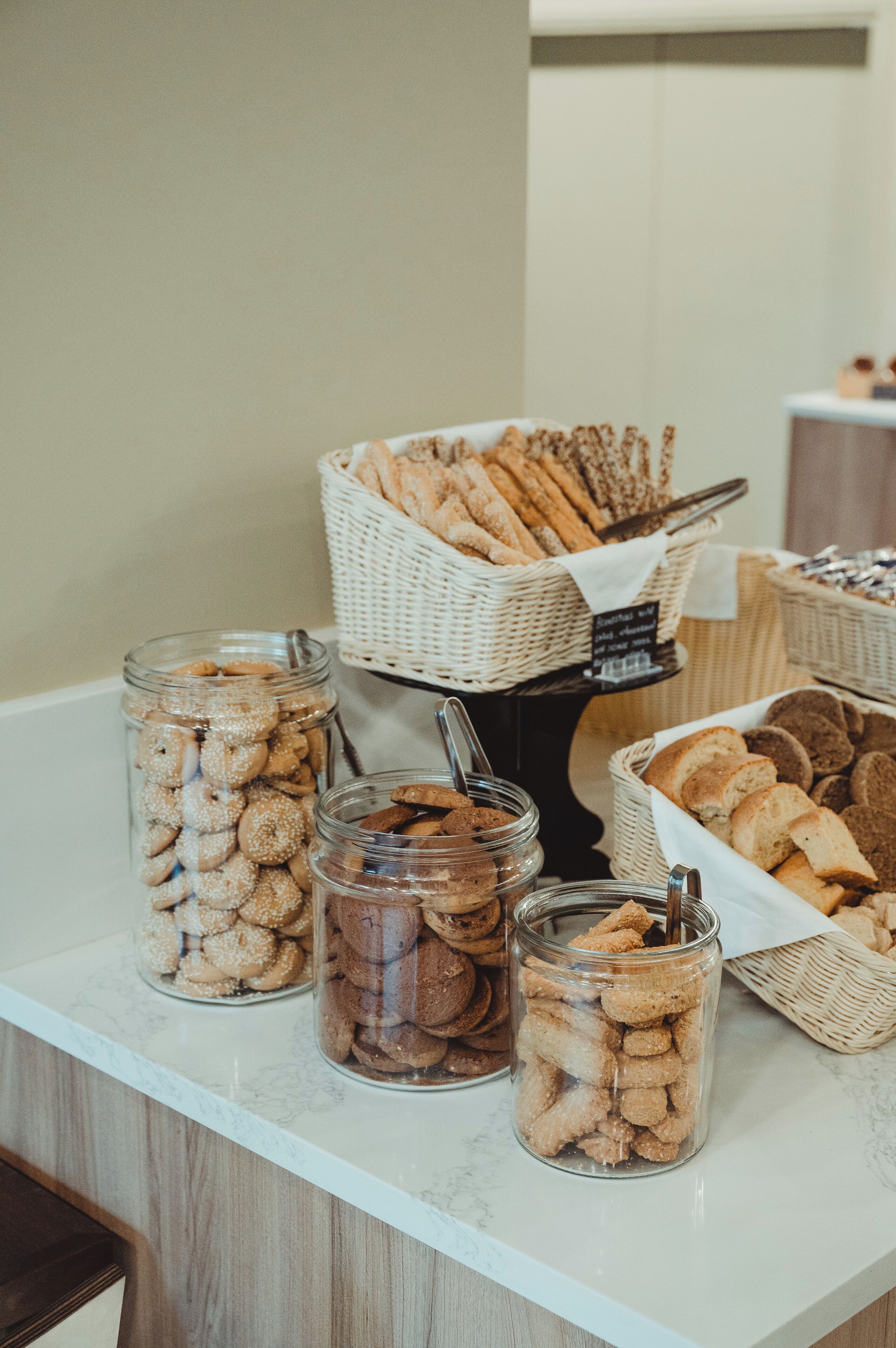 A buffet table with various food items including cookies and bread.