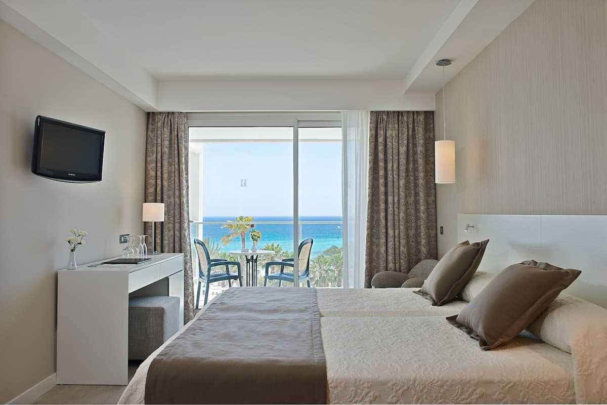 Double Room, Balcony, Sea View | Minibar, in-room safe, desk, iron/ironing board