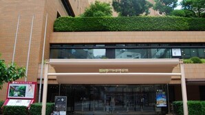 A hotel entrance with a covered walkway, glass doors, and a signboard. - Fukuoka Garden Palace (Fukuoka)