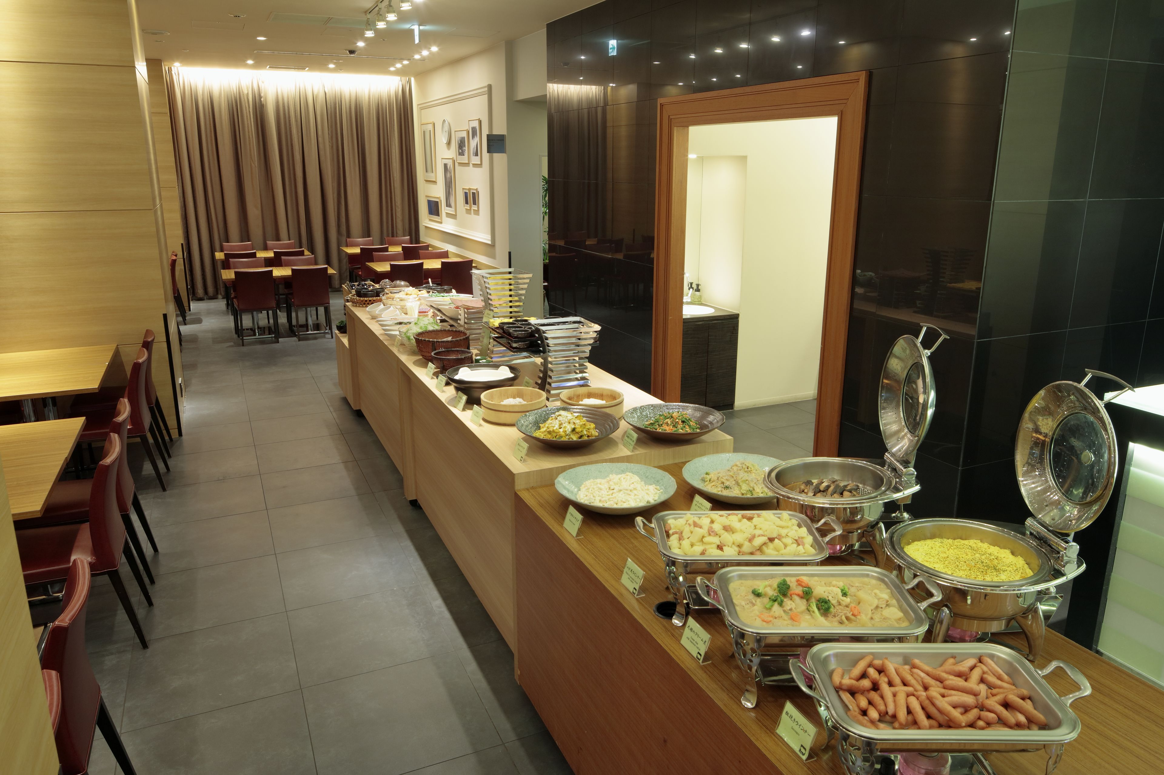 A buffet area with various food stations and seating arrangements.