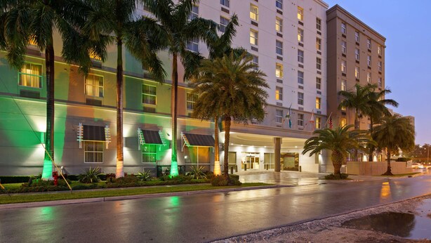 A multi-story hotel with a modern facade, large windows, and a well-lit entrance. - Best Western Plus Miami Intl Airport Hotel & Suites Coral Gables (Miami)