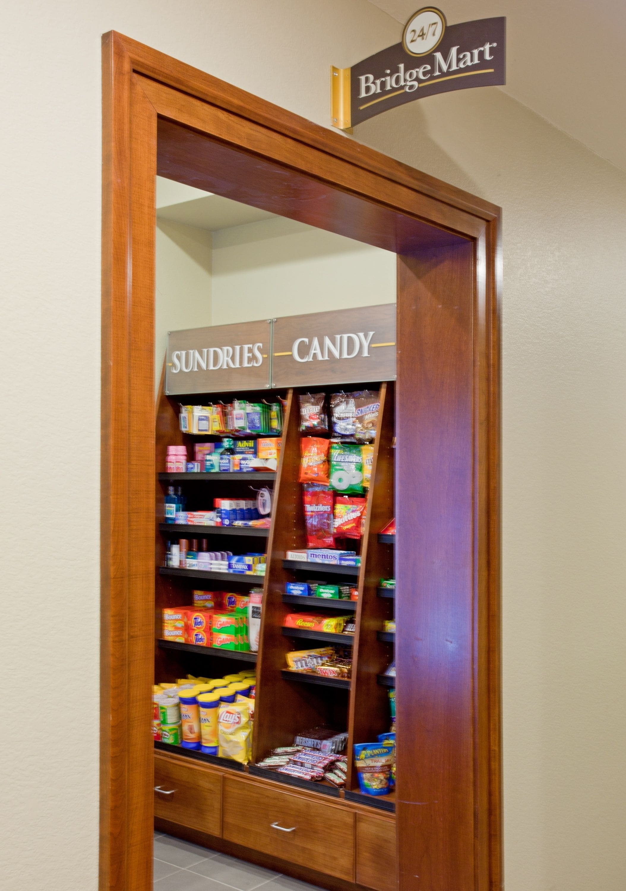 A wooden-framed mirror with a sign above it indicating a BridgeMart store inside.