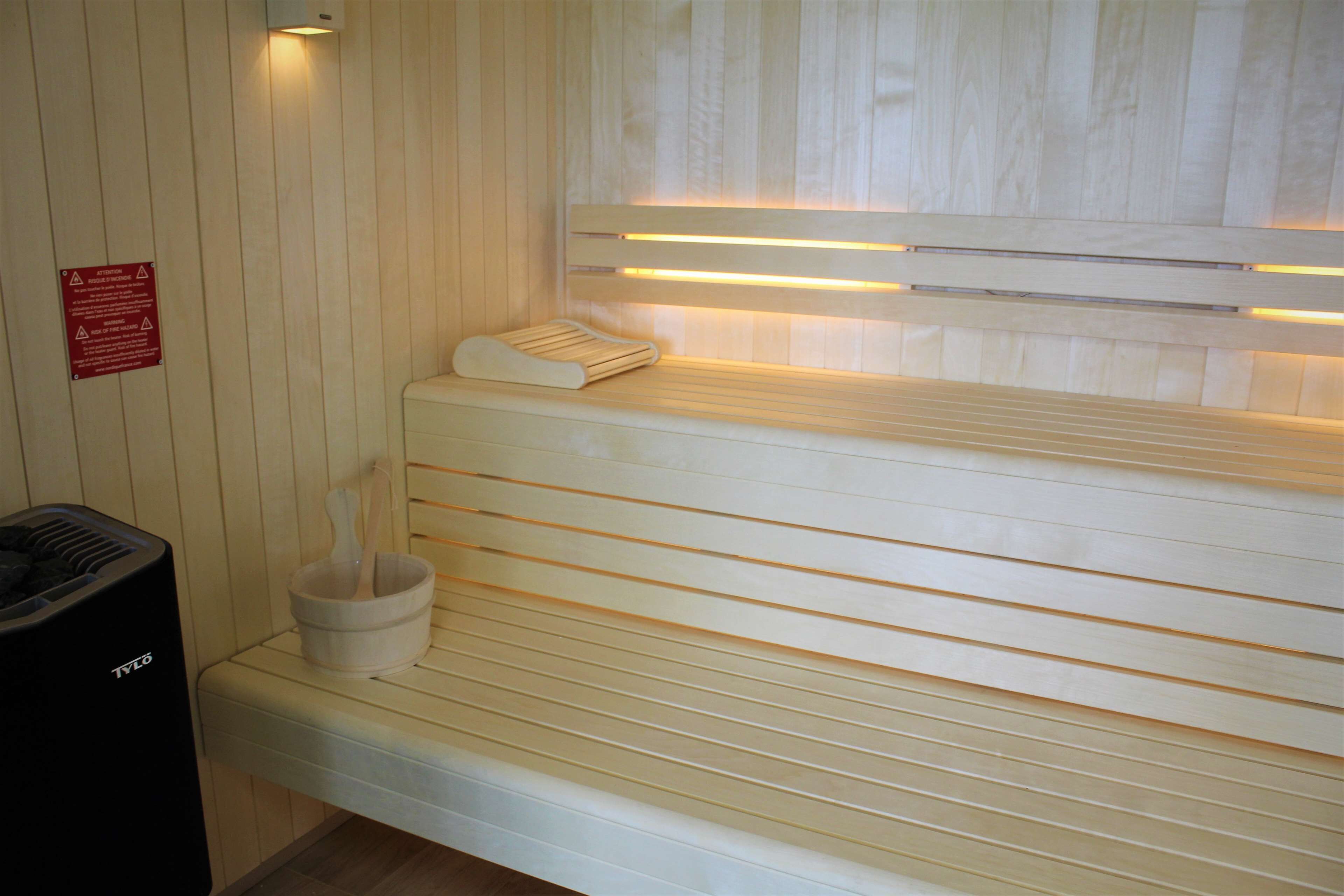 Una sauna con panche in legno e riscaldatore a panche.
