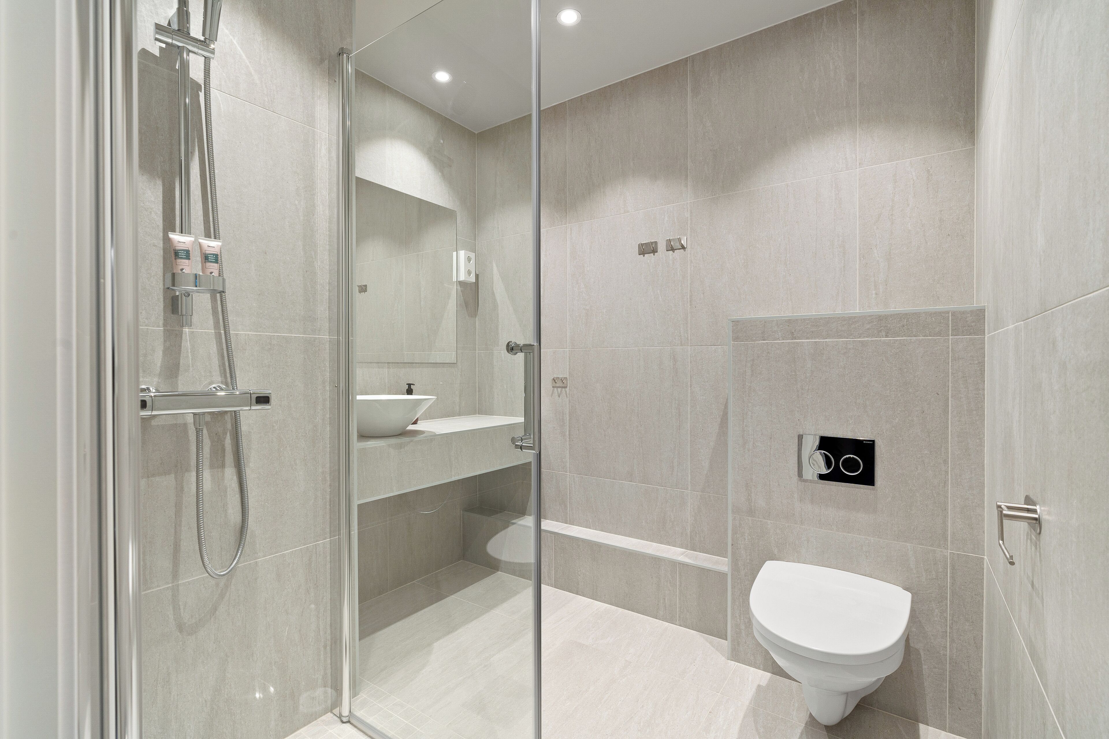 premium studio suite | bathroom | shower, eco-friendly toiletries, heated floors, towels