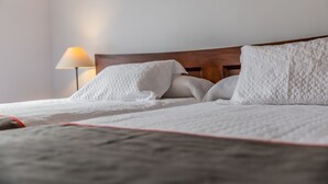 A neatly made bed with white bedding and a wooden headboard. - Hotel Las Errizas by Vivere Stays (Alcala del Valle)