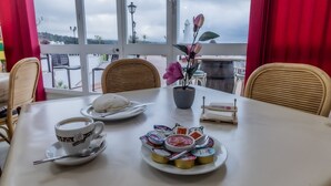 A table with a cup of coffee, a plate of pastries, and a small potted plant. - Hotel Las Errizas by Vivere Stays (Alcala del Valle)