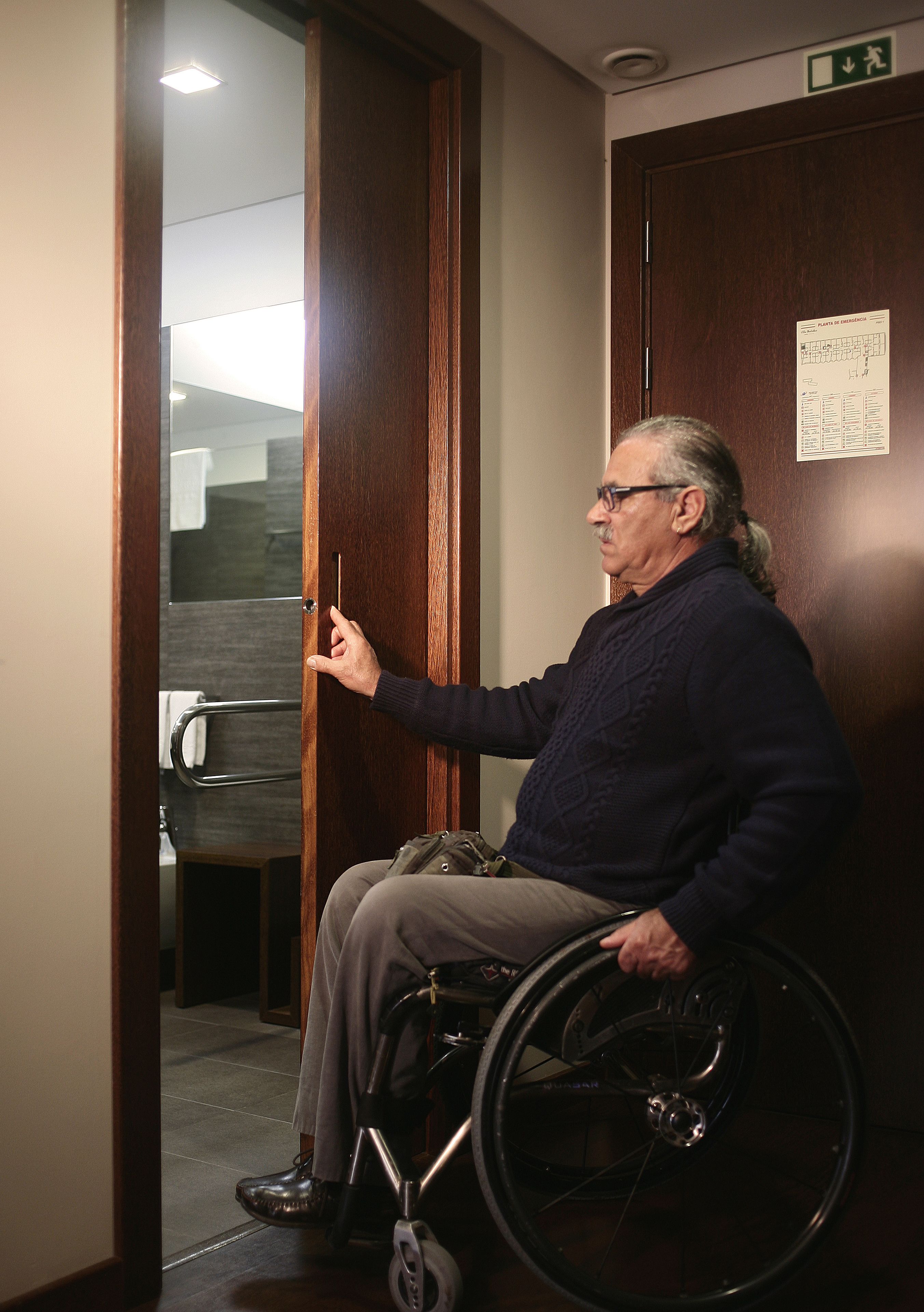 A person in a wheelchair at a hotel entrance.