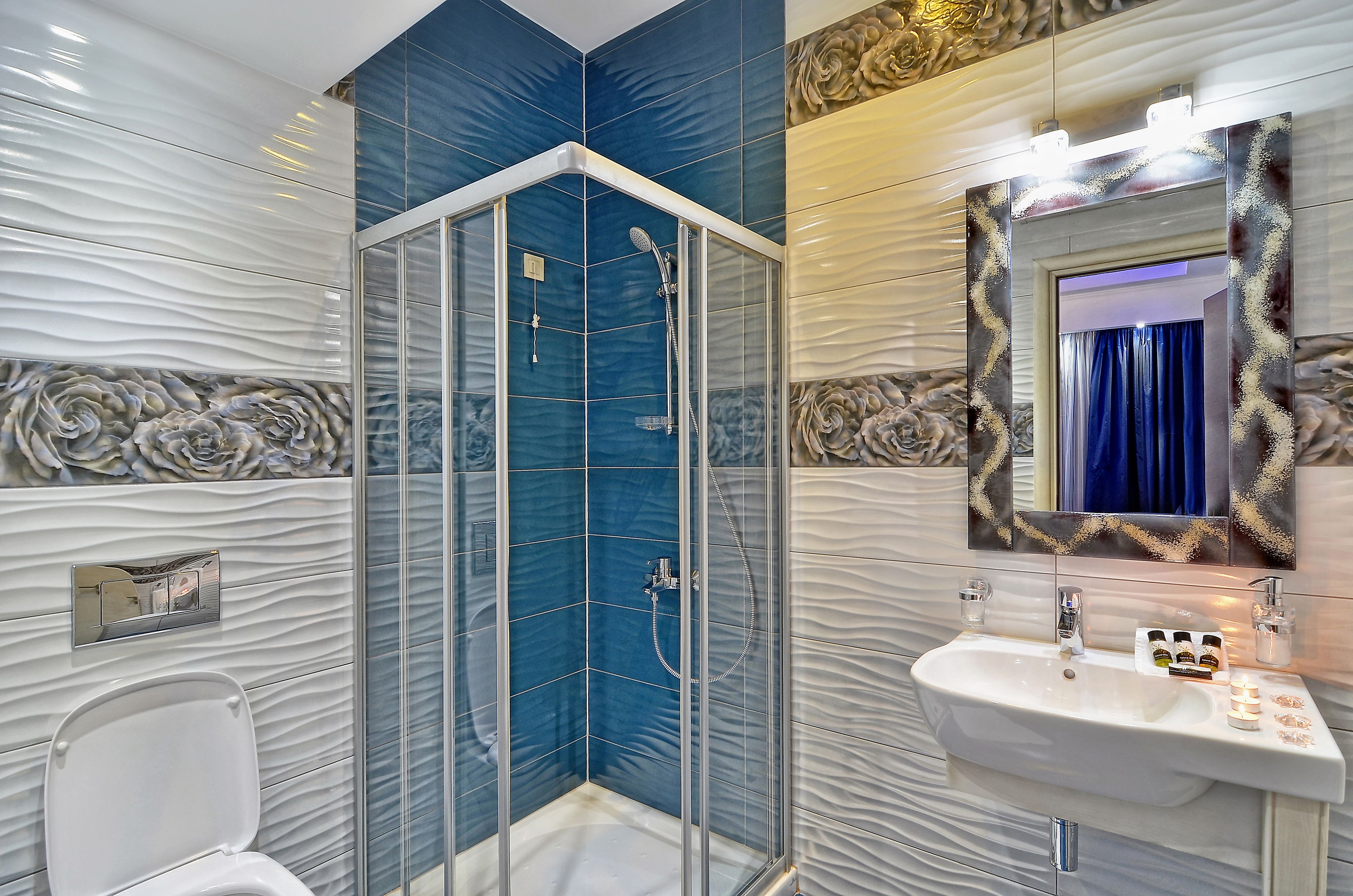 deluxe room | bathroom | rainfall showerhead, designer toiletries, hair dryer, slippers