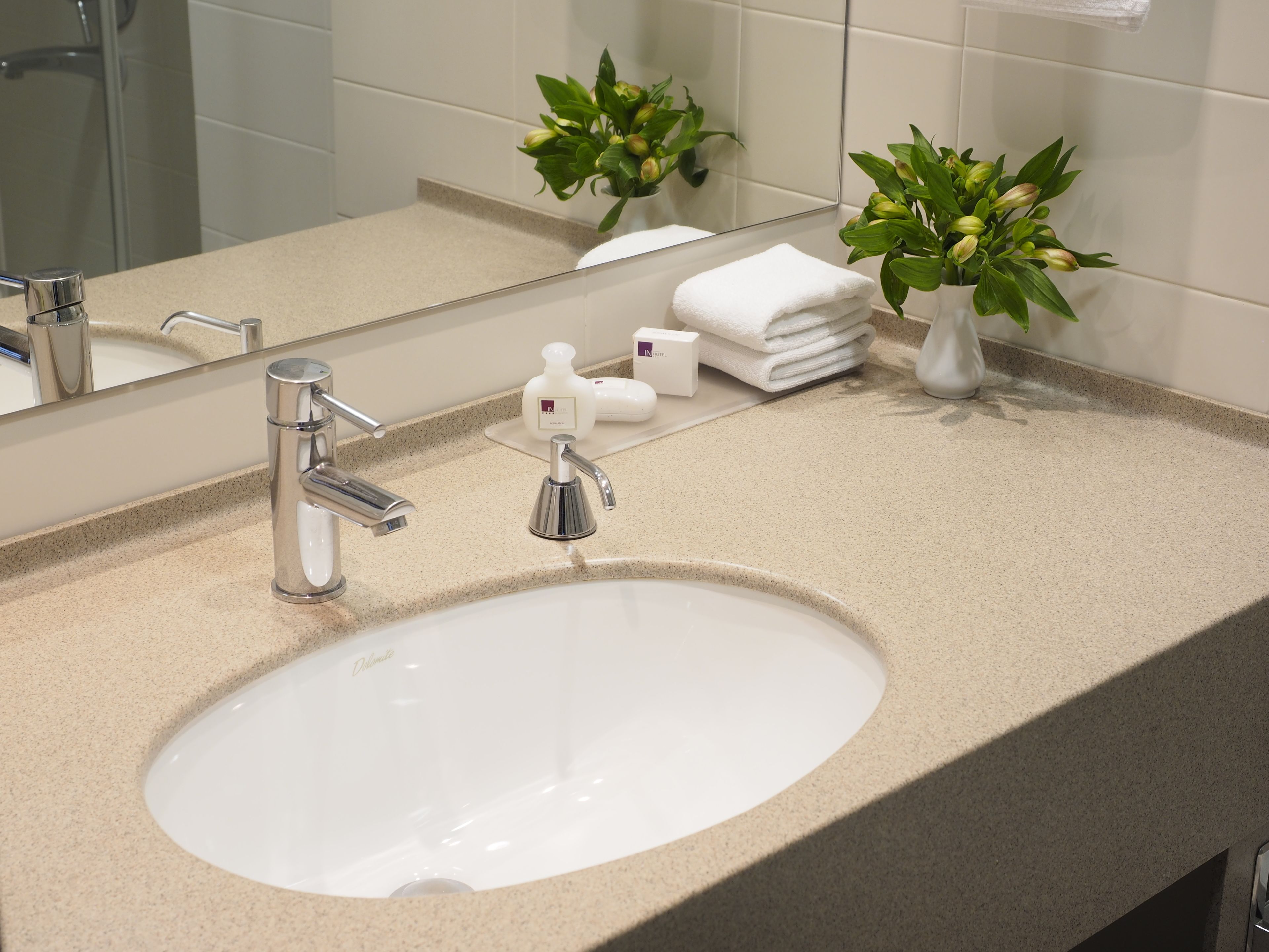 eco-friendly toiletries, hair dryer, slippers, towels