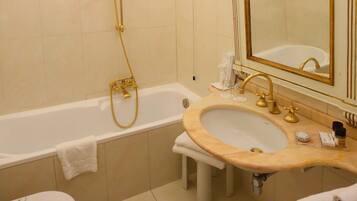 A bathroom with a bathtub, a sink, and a toilet.