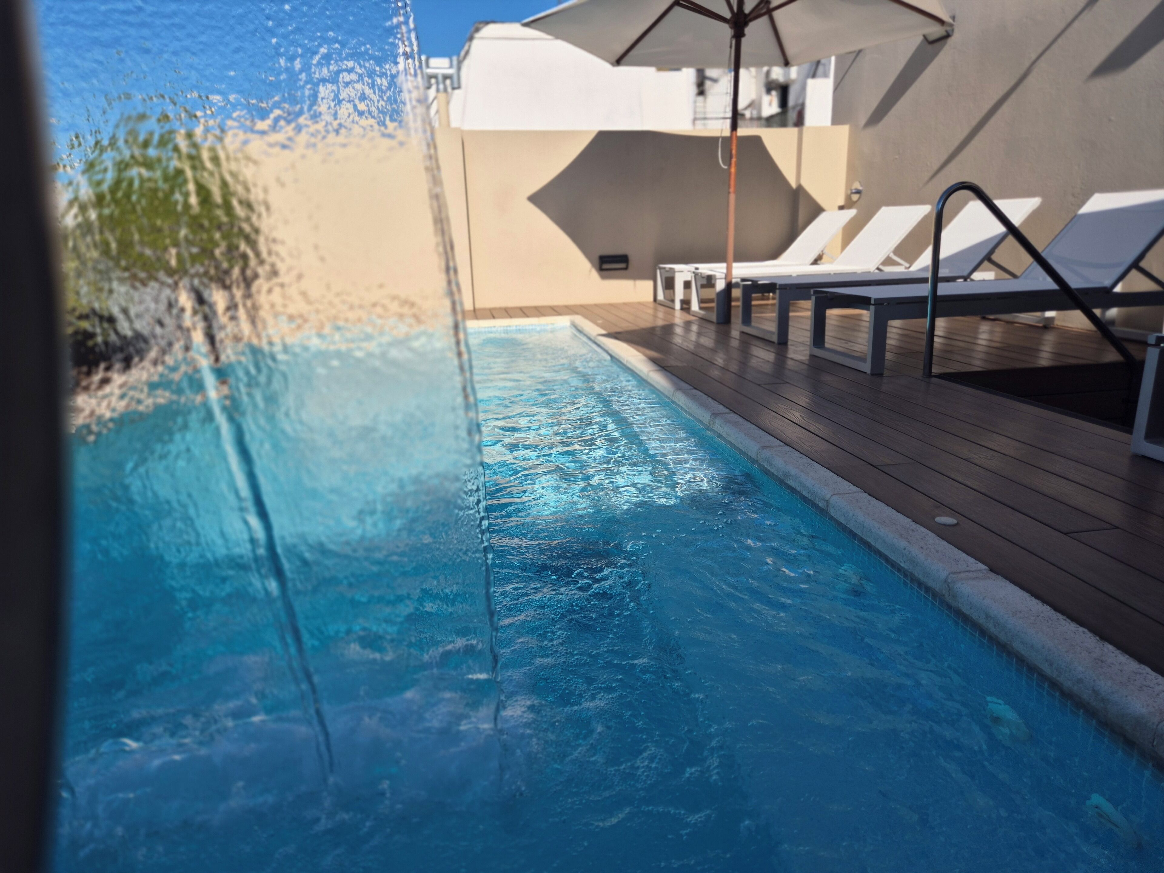 outdoor pool, pool umbrellas, pool loungers