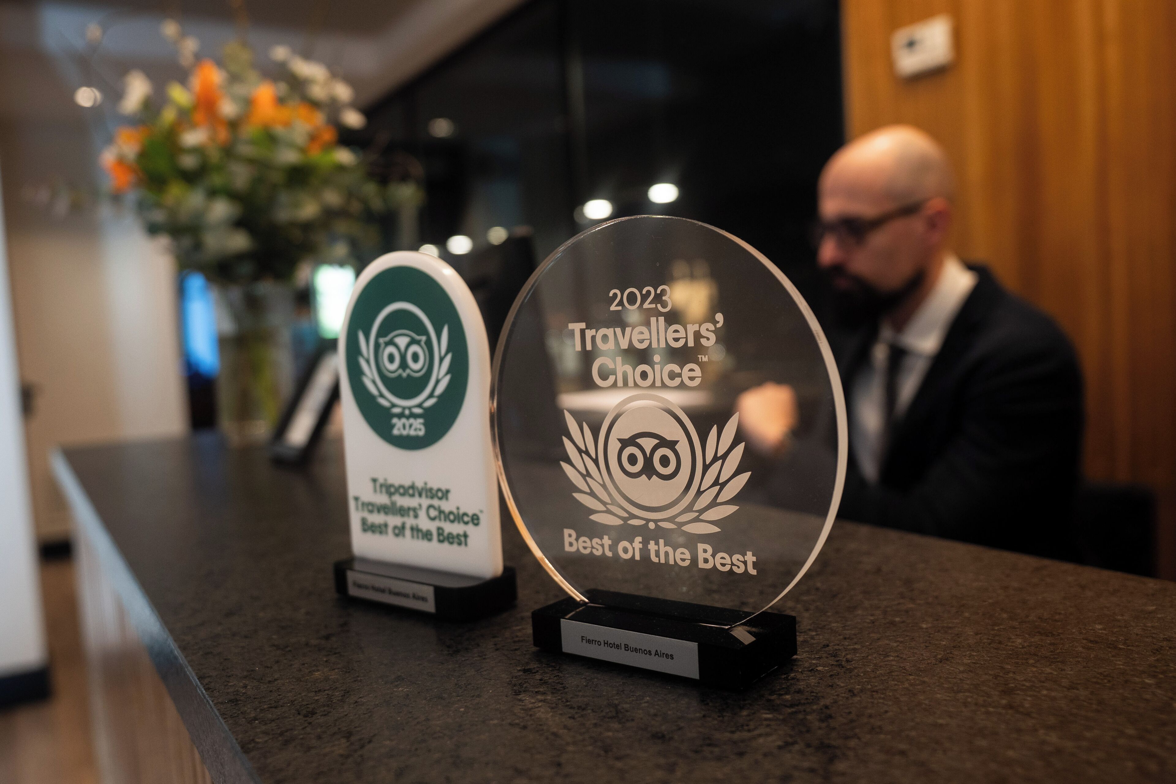 Two awards on a counter, one labeled '2023 Travellers' Choice Best of the Best' and the other '2023 Travellers' Choice Best of the Best'.