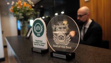 Two awards on a counter, one labeled '2023 Travellers' Choice Best of the Best' and the other '2023 Travellers' Choice Best of the Best'.