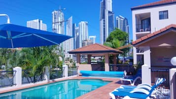 Outdoor pool, a heated pool, pool umbrellas, pool loungers