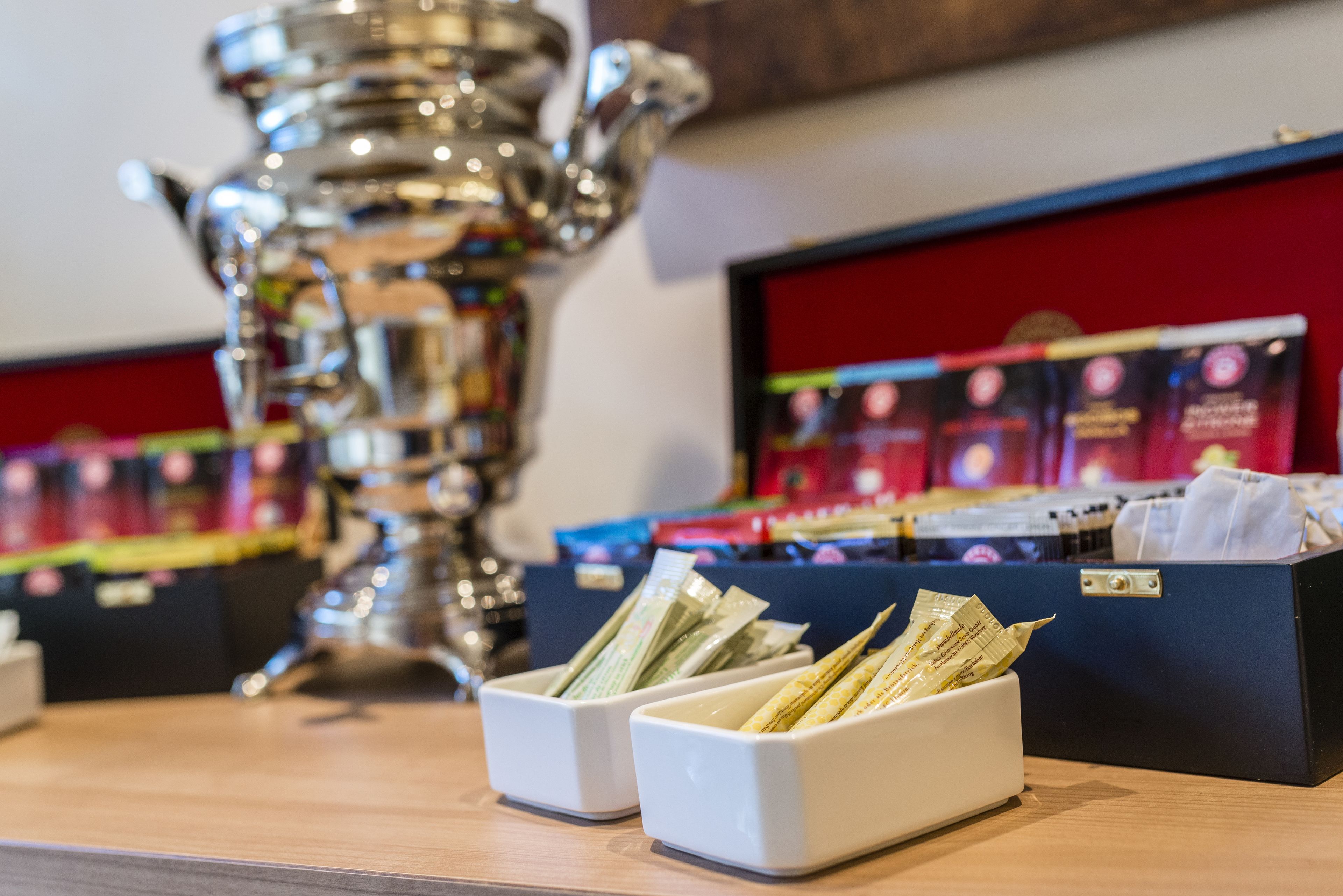 A trophy on a table with two white boxes containing money.