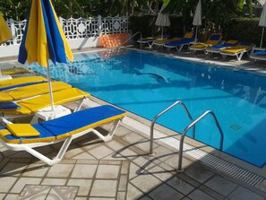 Seasonal outdoor pool, pool umbrellas, pool loungers
