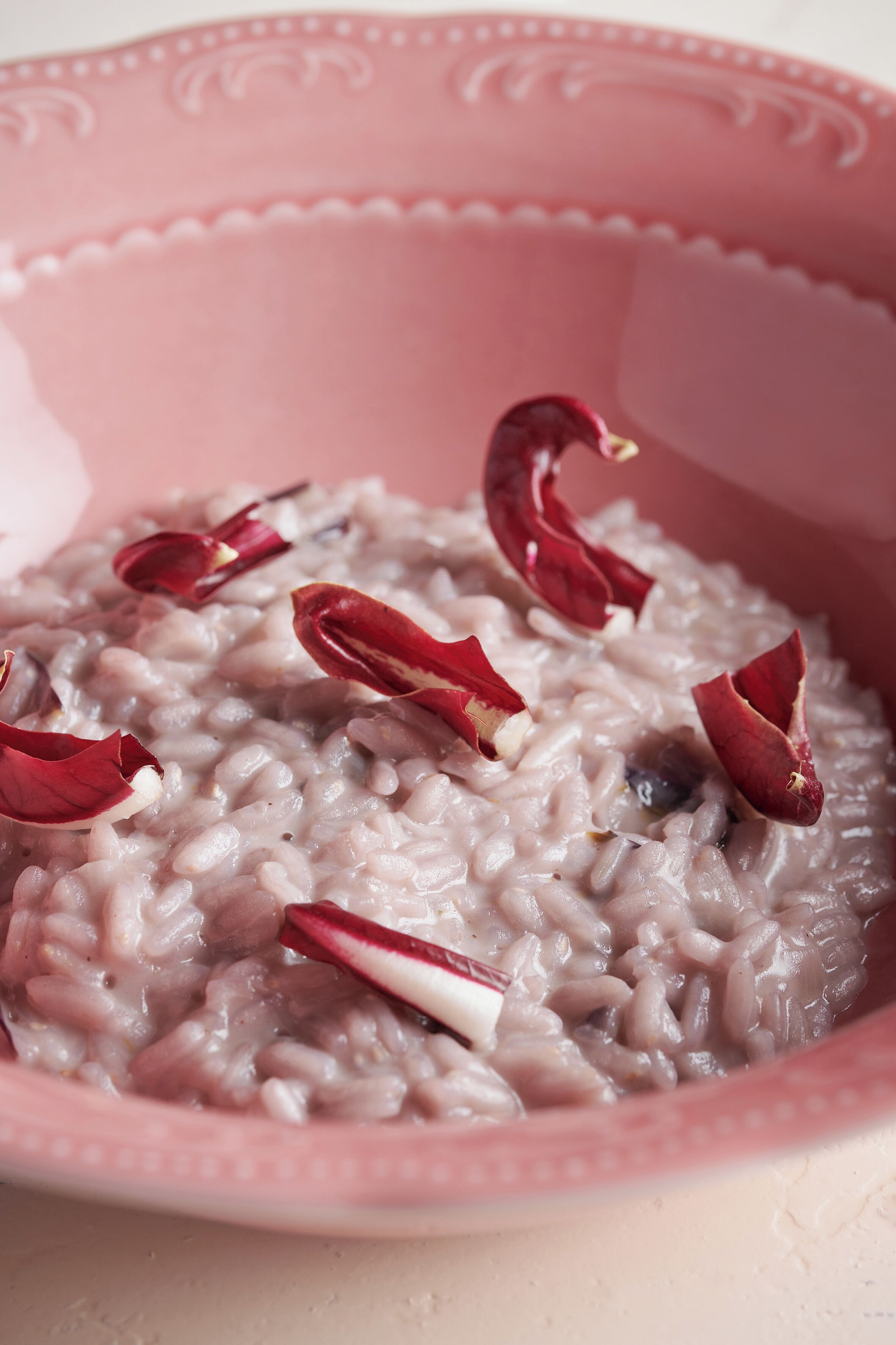 A bowl of rice with red chili flakes.