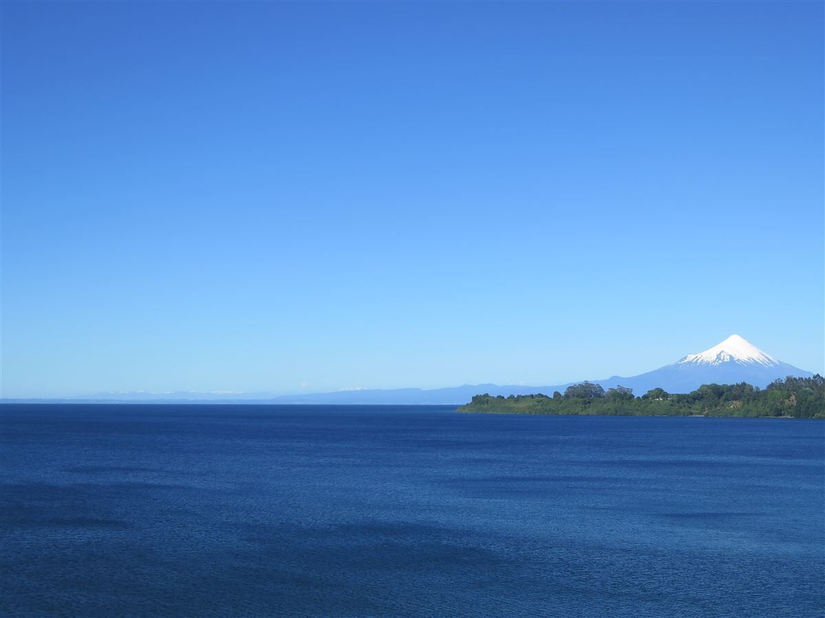 A clear view of a large body of water with a distant mountain range.