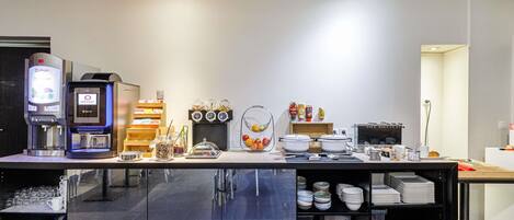 A modern kitchen with a coffee machine, condiment dispensers, and a variety of kitchenware.